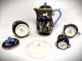 a blue and gold tea set with matching cups and saucers