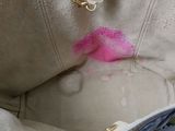 a purse that has a pink stain on the inside of it