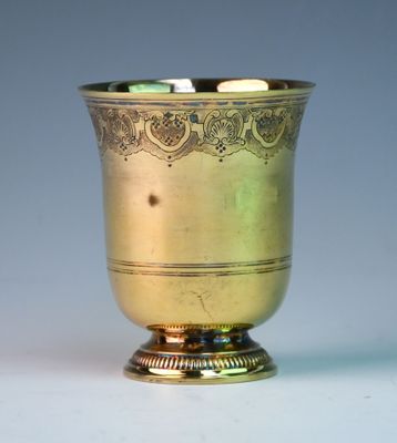a gold cup that is sitting on a table