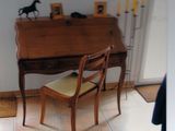 a small desk with a chair in the corner of the room