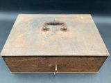 an old metal box with a lock on top of it