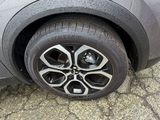 a close up of a car ' s tire on the pavement