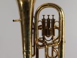 an old brass instrument with a bell on a white background