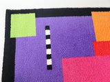 the rug is made of multicolored squares and squares