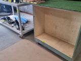 a wooden cabinet with a green grass on top of it