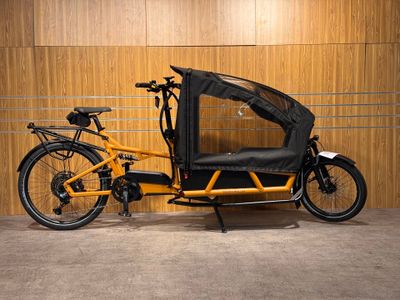 a yellow bike with a black seat in a garage