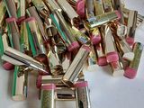 a pile of lipsticks that are on a table