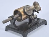 an old fashioned machine that is sitting on a stand