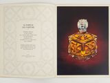 an open book with a picture of a perfume bottle on it
