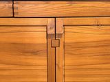 a close up of a wooden cabinet with two doors