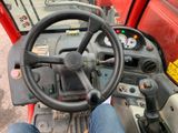 a close up of a steering wheel on a red tractor