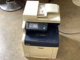 an image of a multi - function printer sitting on the floor