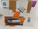 packaging of a hp officejet pro printer sitting on top of a table