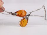 someone is holding a piece of glass with a piece of amber on it