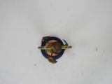 a small blue and gold object on a white surface