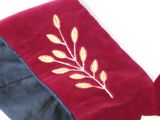 a red and blue scarf with a gold leaf on it