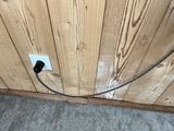 a picture of an electrical outlet in a wood paneled room