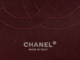 chanel, a brown leather bag with a logo on the front