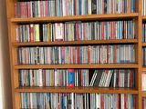 a book shelf with a lot of dvd ' s on it