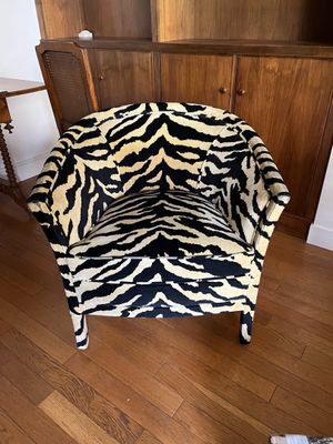 a zebra print chair in the corner of a living room
