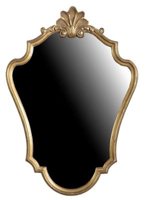 un miroir à cadre doré accroché à un mur blanc sur fond noir