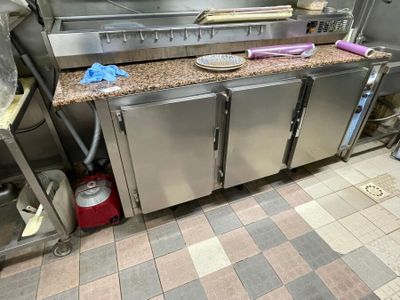 a large kitchen with a lot of stainless steel appliances