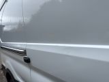 a white van that is parked on the side of the road