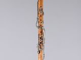 a clarinet with a wooden body and silver decorations on it