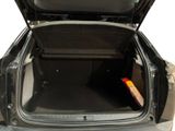 an open trunk of a car with a book in it