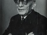 an old black and white photo of a man wearing glasses