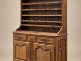 an antique oak bookcase with two doors and shelves
