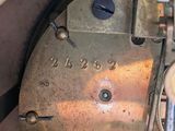 a close up of a clock that has a key on it