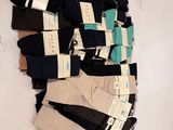 several pairs of men ' s socks are stacked on top of each other
