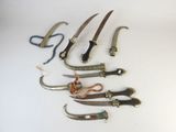 several different types of knives are lined up on a white surface