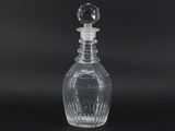 clear glass decanter with a clear stopper on a black background