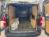the back of a van with the doors open and the back of the van filled with bottles of water