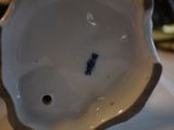 a close up of a white porcelain object on a table