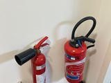 a fire extinguisor next to a cardboard box