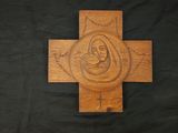 a wooden cross with an image of a woman and child on it