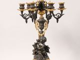 an antique bronze candelabra with a black and gold finish