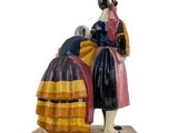a figurine of two people standing next to each other