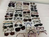 many pairs of glasses laid out on a table