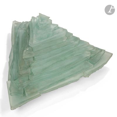 a glass sculpture of a mountain on a white surface
