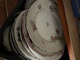 a lot of plates that are stacked up in a drawer