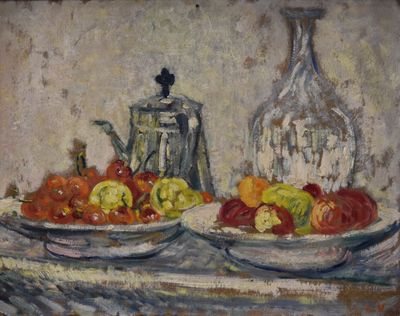 two plates of fruit on a table next to a bottle