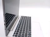 a laptop computer sitting on a table with a keyboard