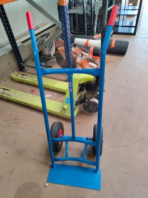 a blue hand truck with a blue handle in a warehouse
