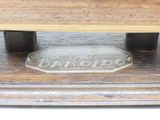 a glass plaque on the top of a wooden table