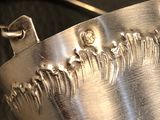 a close up of a silver bracelet with a skull on it
