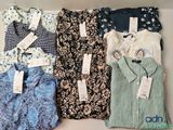 several shirts are lined up in a row on a shelf